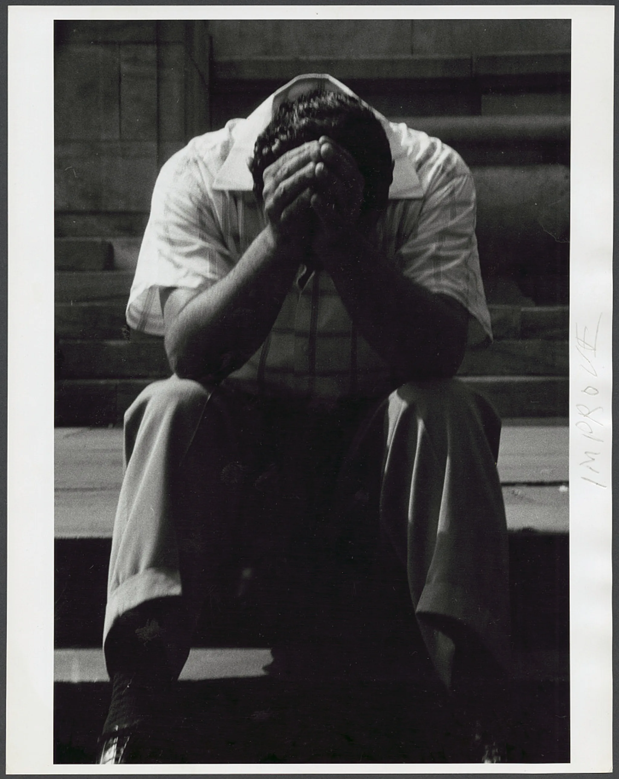 Man sitting with his head in his hands